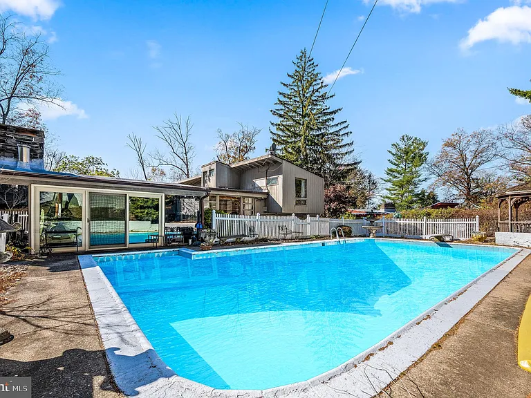 Philly home of boxer Muhammad Ali and family, midcentury modern home exterior with in-ground pool in Morris Park Philadelphia