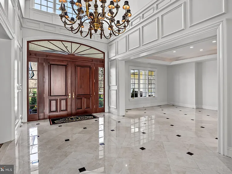 Classic NJ mansion in Moorestown New Jersey, interior with sun drenched foyer and massive chandelier