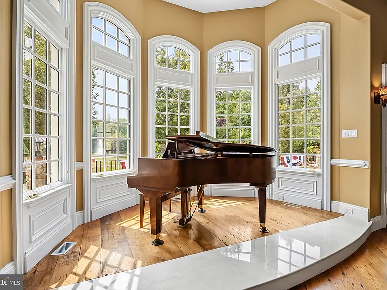 Classic NJ mansion in Moorestown New Jersey, interior with baby grand piano in a sun-drenched window