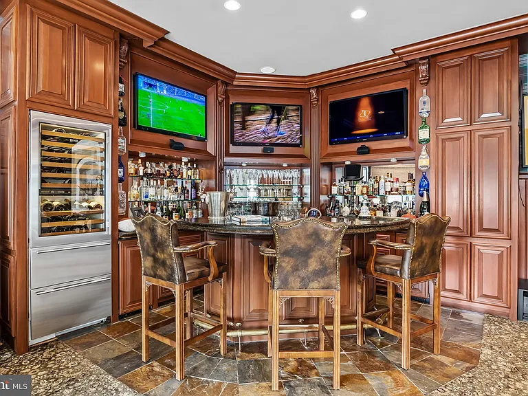 Classic NJ mansion in Moorestown New Jersey, dark wood interior entertainment space with wet bar and tv