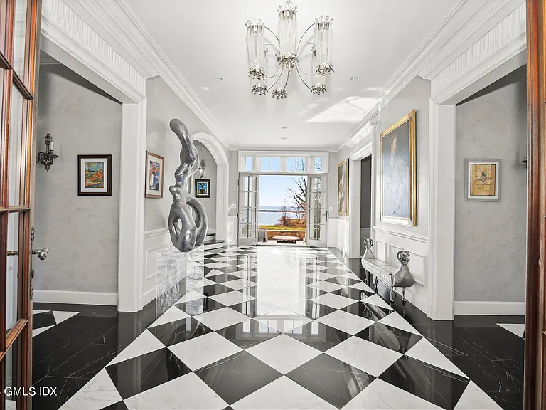 Massive Long Island Sound Mansion, interior of Cedarcliff Road in Riverside Connecticut with a black and white checkerboard foyer