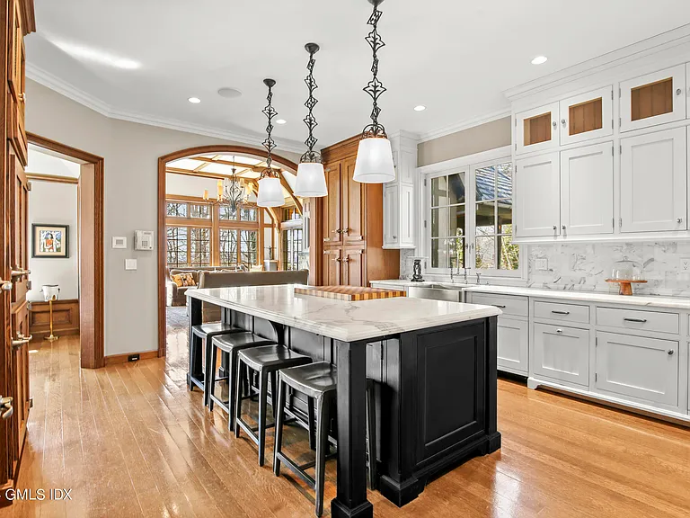 Massive Long Island Sound Mansion, interior of Cedarcliff Road in Riverside Connecticut with constrasting kitchen and black wood island