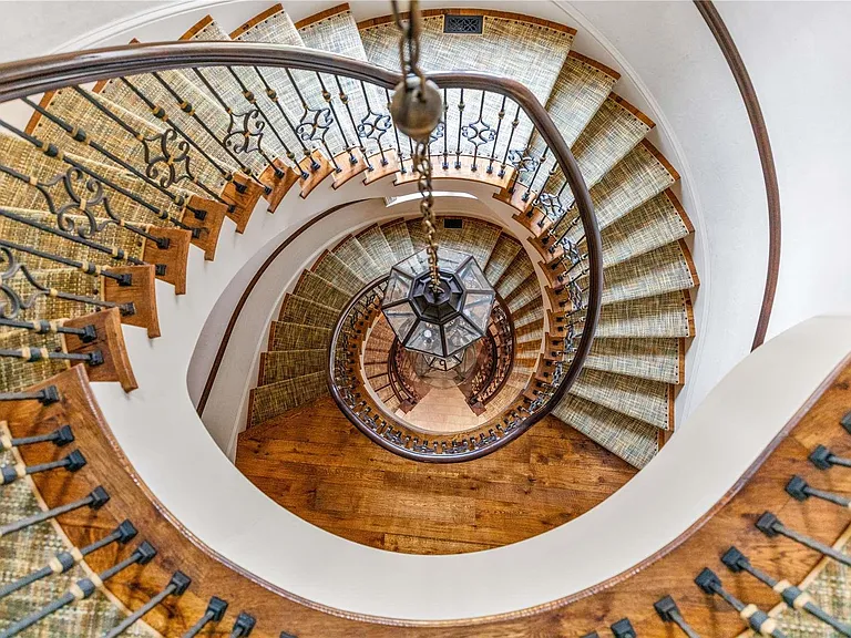 Old Westbury Mansion, exterior of Spring Hill Lane estate with white seating area large spiral staircase in wrought iron and wood