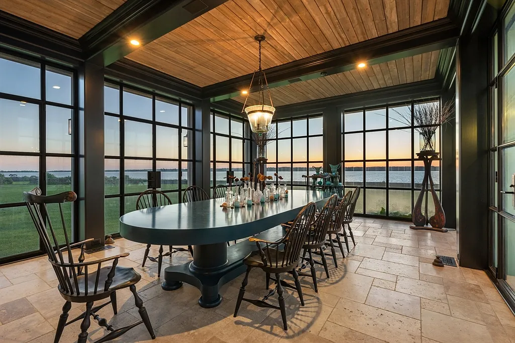 Most expensive house in Rhode Island, interior of 441 West Main Road in Little Compton with massive three seasons dining hall with large black wood table