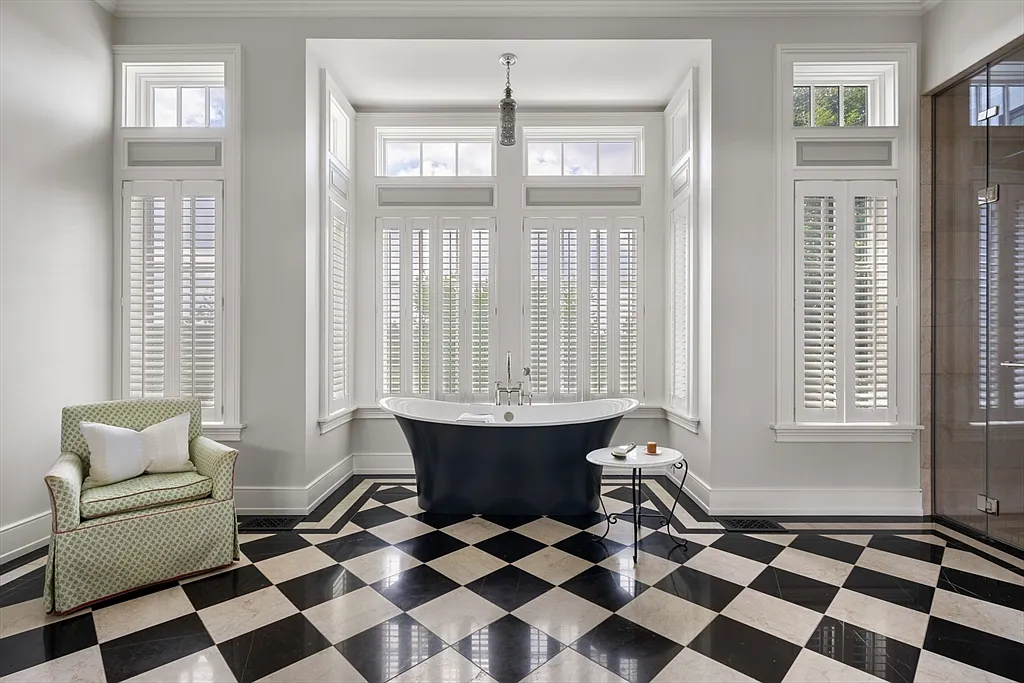 Most expensive house in Rhode Island, interior of 441 West Main Road in Little Compton with sun drenched master bathroom with soaking tub and vintage black and white checkerboard tile