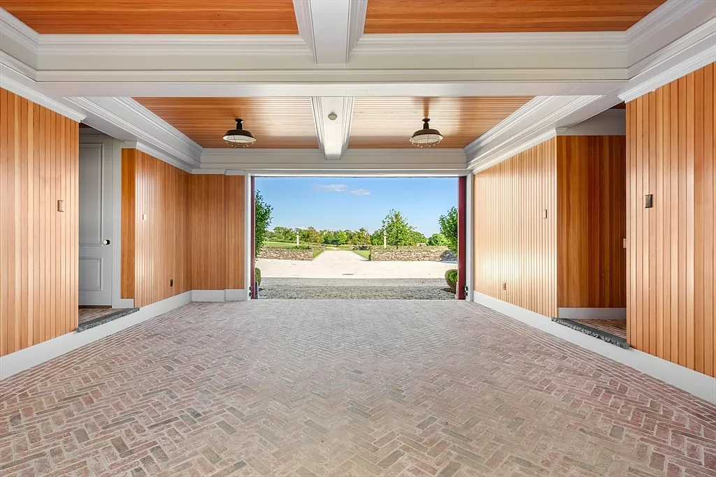 Most expensive house in Rhode Island, interior of 441 West Main Road in Little Compton with sun drenched tiled walkway space connecting buildings