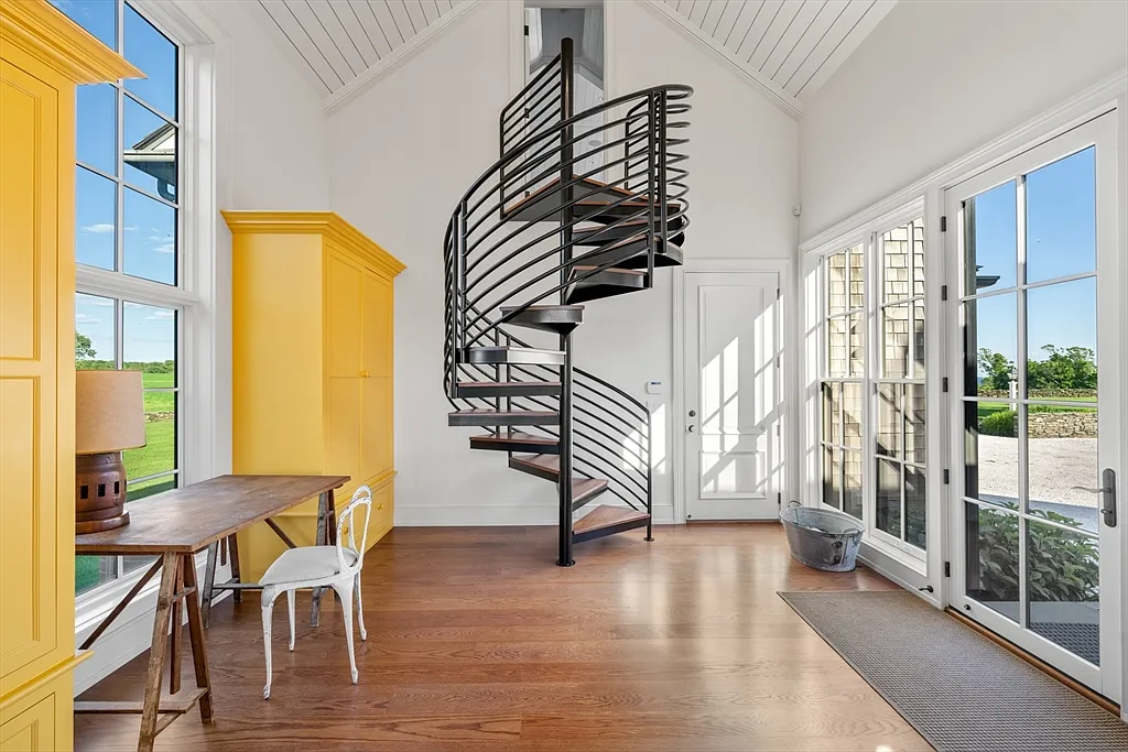 Most expensive house in Rhode Island, interior of 441 West Main Road in Little Compton with massive wrought iron spiral staircase