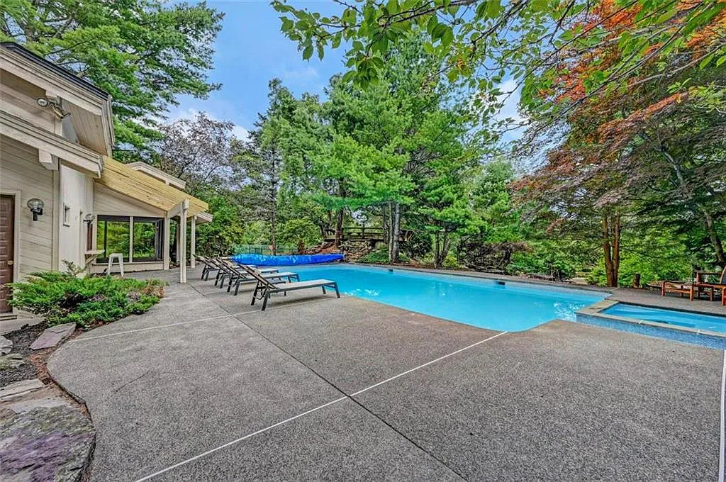 Poconos Palace in East Stroudsburg Pennsylvania, in-ground exterior pool with built-in hot tub