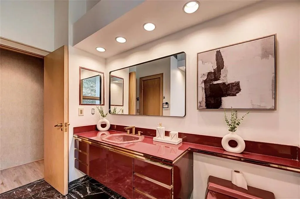 Poconos Palace in East Stroudsburg Pennsylvania, large 1980s bathroom with red formica vanity and modern art