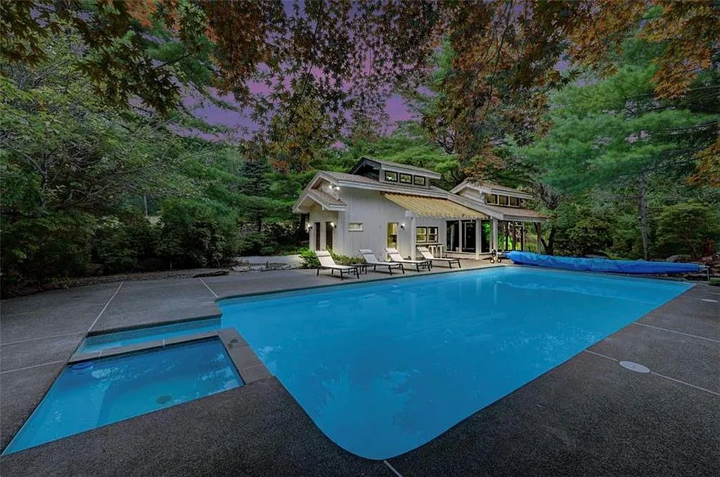 Poconos Palace in East Stroudsburg Pennsylvania, in-ground exterior pool with built-in hot tub