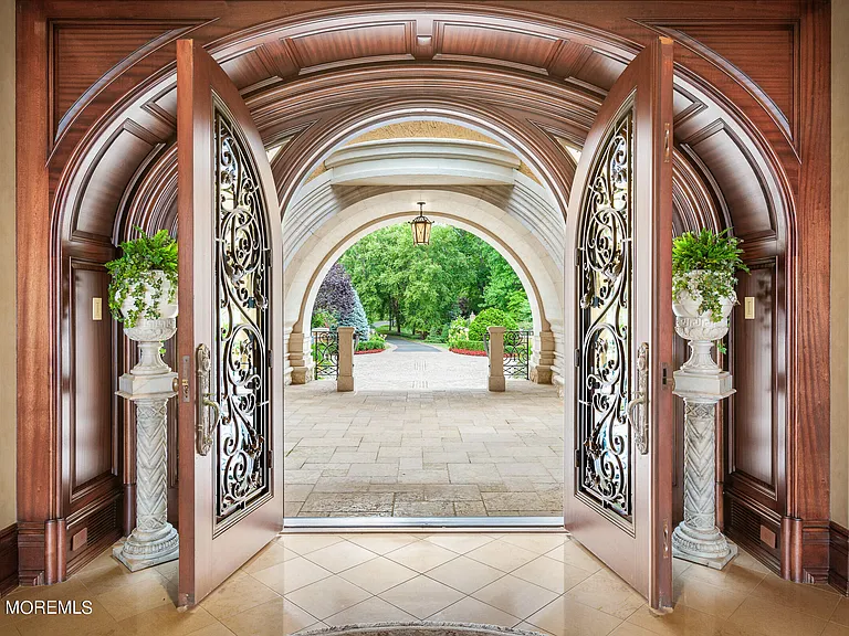 Massive Tuscan Palace in New Jersey on the Rumson and Navasink Rivers, interior two-story Tuscan tiled and wood foyer with double doors