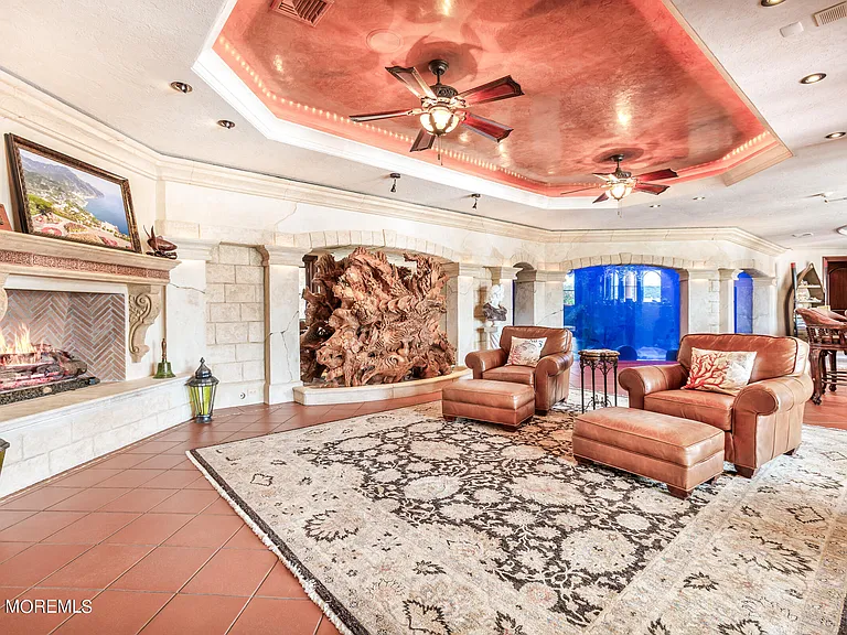 Massive Tuscan Palace in New Jersey on the Rumson and Navasink Rivers, terra cotta tiled seating area with fireplace