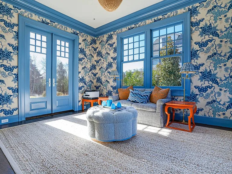 Old money Hamptons estate 134 Herrick Rd in Southampton New York, interior sitting and sun room with hand painted wallpaper and blue accent trim