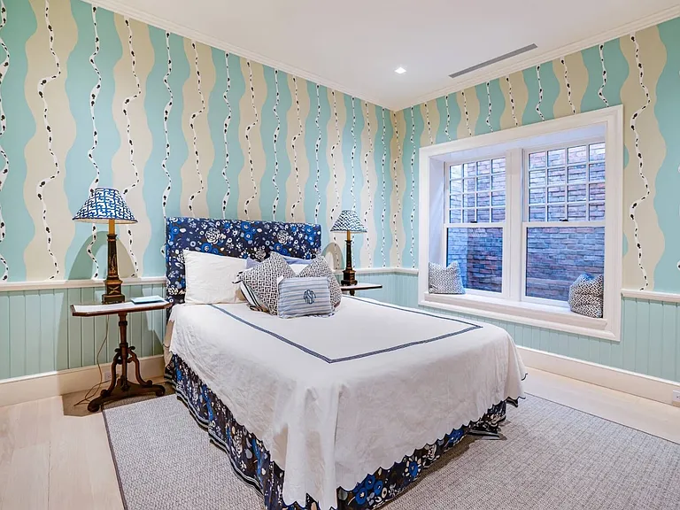 Old money Hamptons estate 134 Herrick Rd in Southampton New York, modern country style guest suite with striped wallpaper and natural light