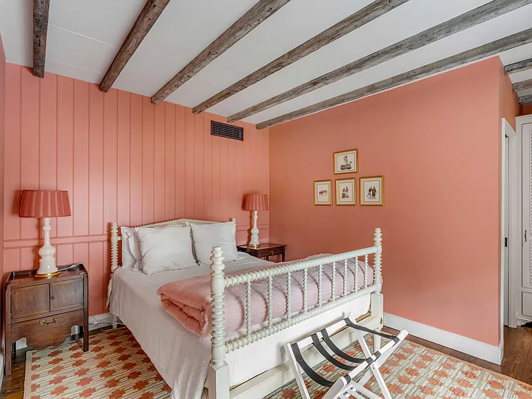 Scott Bessent's Charleston Waterfront Mansion, classic southern bedroom with exposed wood beams and natural light