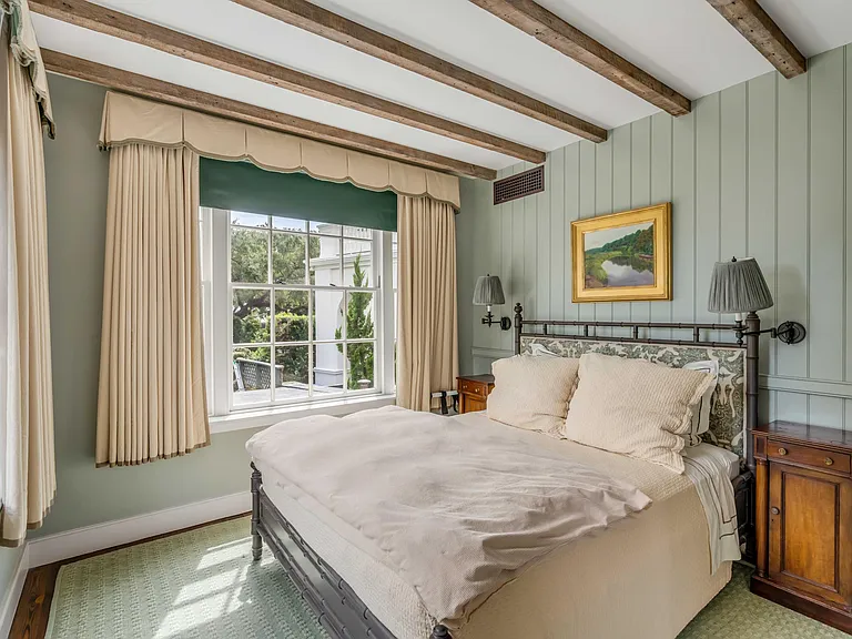 Scott Bessent's Charleston Waterfront Mansion, classic southern bedroom with exposed wood beams and natural light