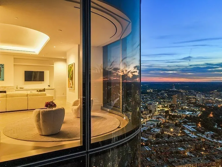 Boston's Most Expensive Penthouse Apartment, curved glass windows overlooking the city of Boston from the 58th floor