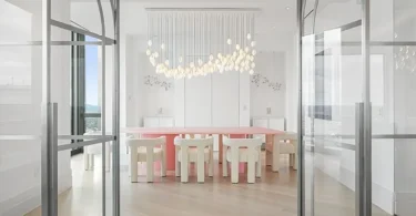 Boston's Most Expensive Penthouse Apartment, large dining room with double glass doors and massive pink dining table