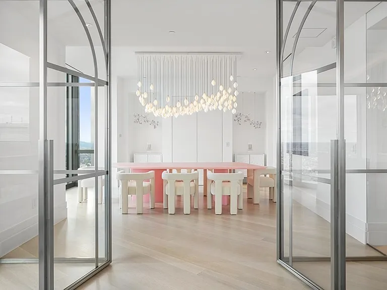 Boston's Most Expensive Penthouse Apartment, large dining room with double glass doors and massive pink dining table