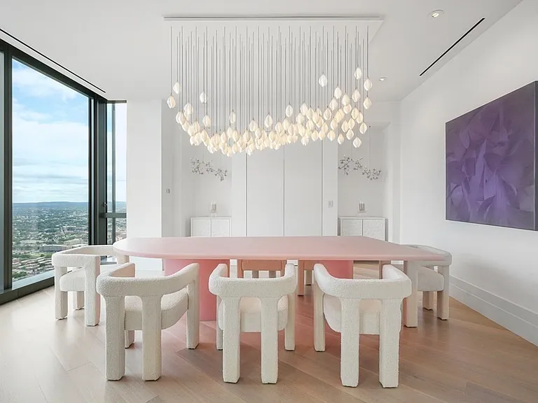 Boston's Most Expensive Penthouse Apartment, large dining room with double glass doors and massive pink dining table