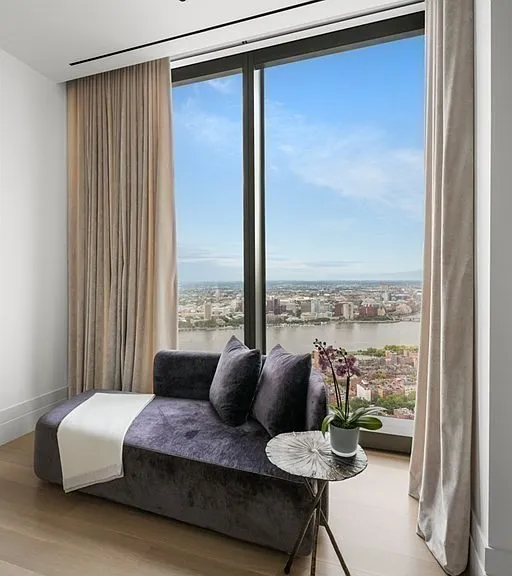 Boston's Most Expensive Penthouse Apartment, soft gray and white master bedroom with modern furniture