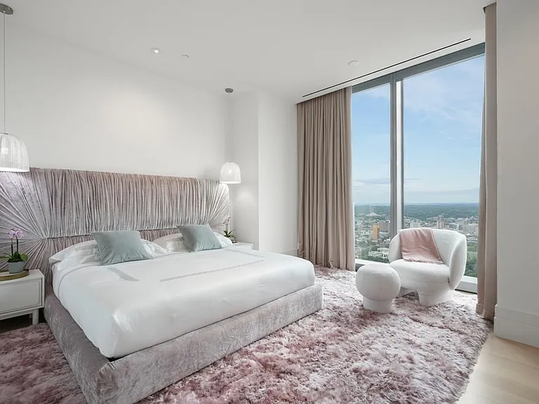 Boston's Most Expensive Penthouse Apartment, soft pink and white master bedroom with modern furniture