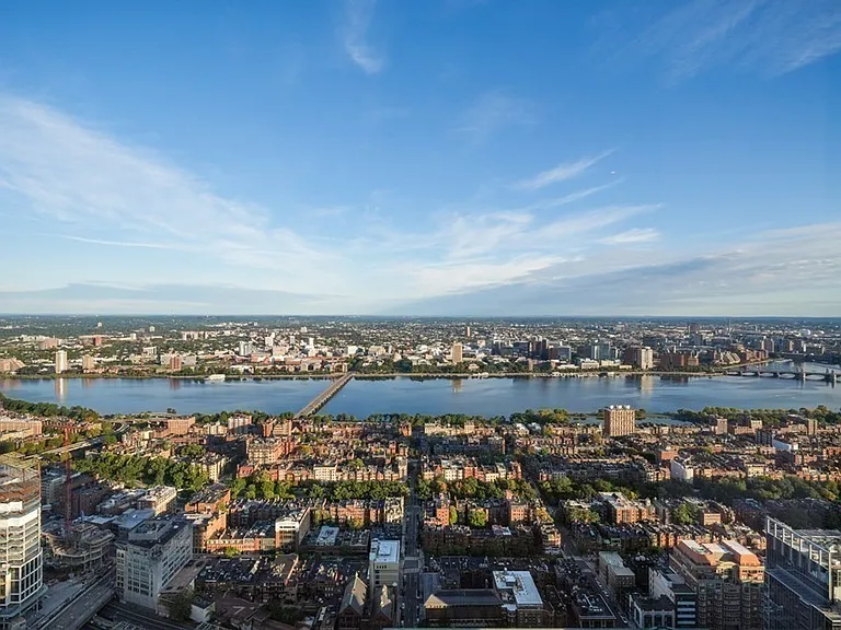 Boston's Most Expensive Penthouse Apartment, curved glass windows overlooking the city of Boston from the 58th floor