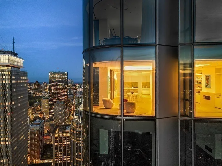 Boston's Most Expensive Penthouse Apartment, curved glass windows overlooking the city of Boston from the 58th floor