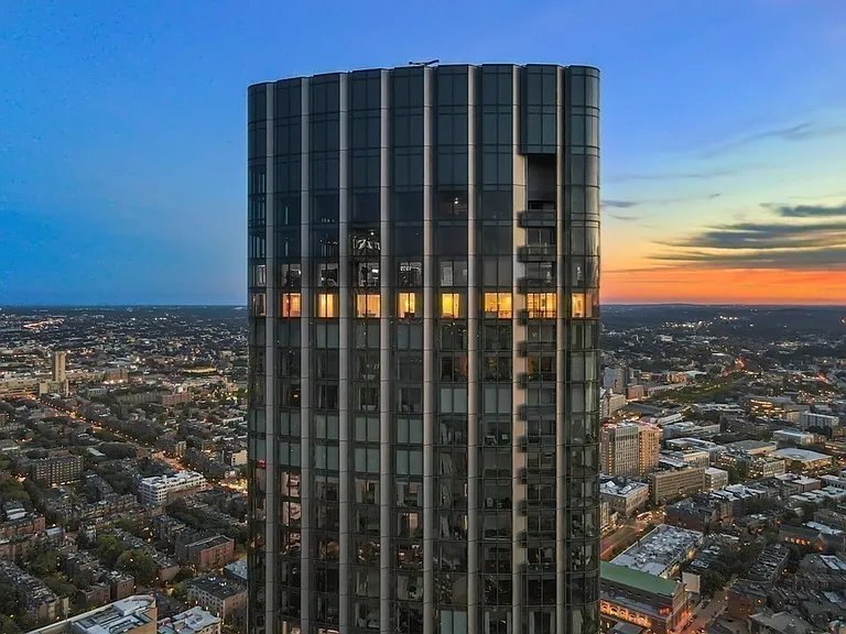 Boston's Most Expensive Penthouse Apartment, curved glass windows overlooking the city of Boston from the 58th floor