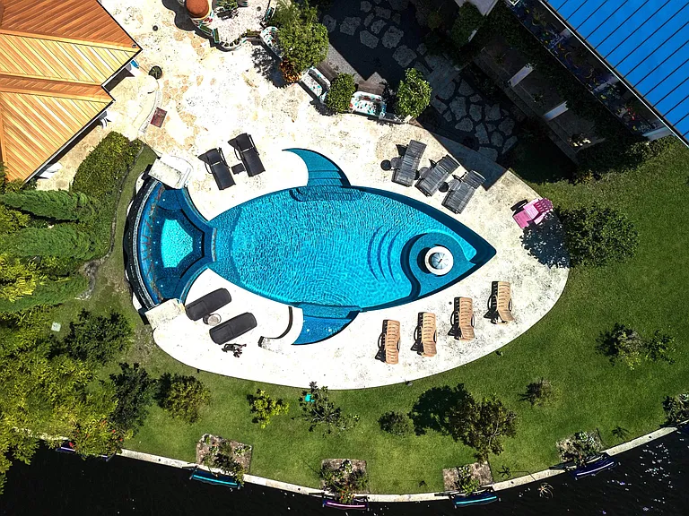 Crazy Florida mansion located at 1201 Marble Way in Boca Raton, exterior view of fish-shaped swimming pool