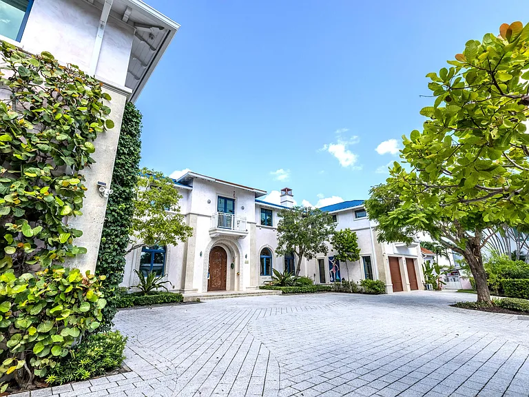 Crazy Florida mansion located at 1201 Marble Way in Boca Raton, exterior view of driveway and garage