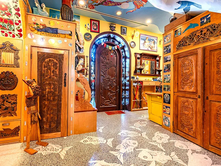 Crazy Florida mansion located at 1201 Marble Way in Boca Raton, interior eclectic foyer with artwork and mosaic staircase