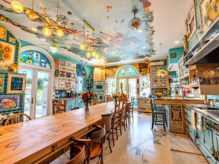 Crazy Florida mansion located at 1201 Marble Way in Boca Raton, la cornue kitchen with massive hand-carved viking boat dining table