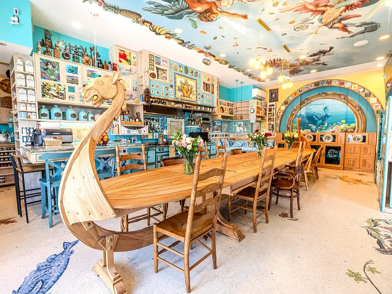 Crazy Florida mansion located at 1201 Marble Way in Boca Raton, la cornue kitchen with massive hand-carved viking boat dining table