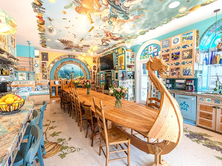 Crazy Florida mansion located at 1201 Marble Way in Boca Raton, la cornue kitchen with massive hand-carved viking boat dining table