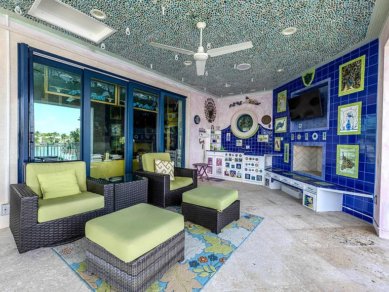 Crazy Florida mansion located at 1201 Marble Way in Boca Raton, exterior lounge space with tile mosiacs