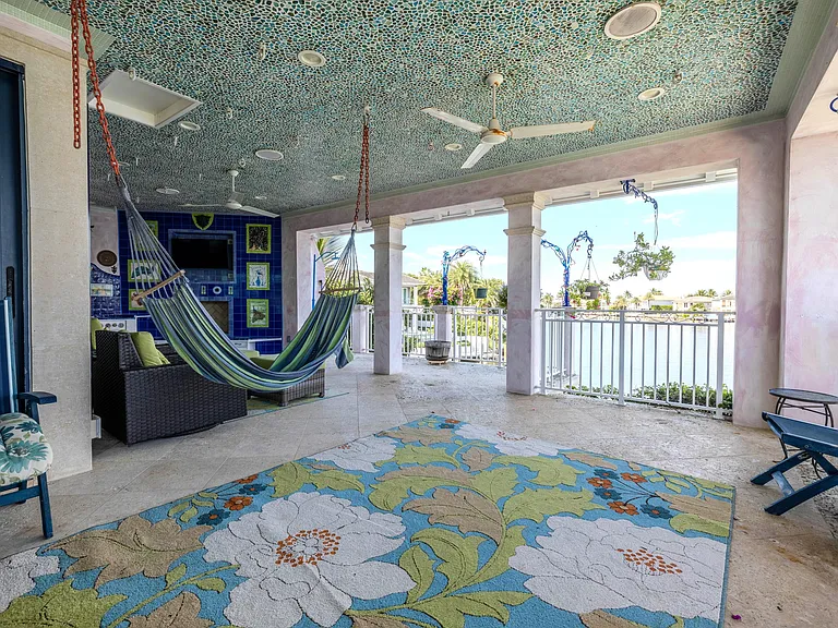 Crazy Florida mansion located at 1201 Marble Way in Boca Raton, exterior lounge space with tile mosiacs