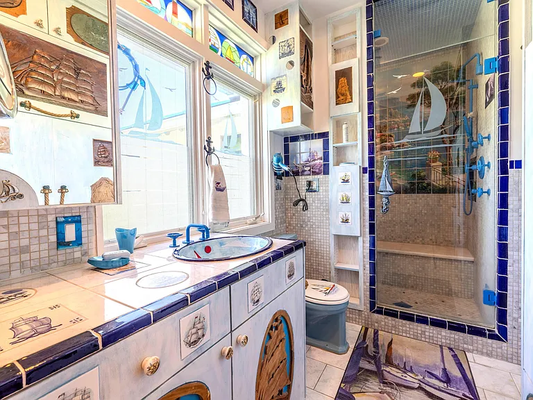 Crazy Florida mansion located at 1201 Marble Way in Boca Raton, interior bathroom and sitting area with tile mosaics