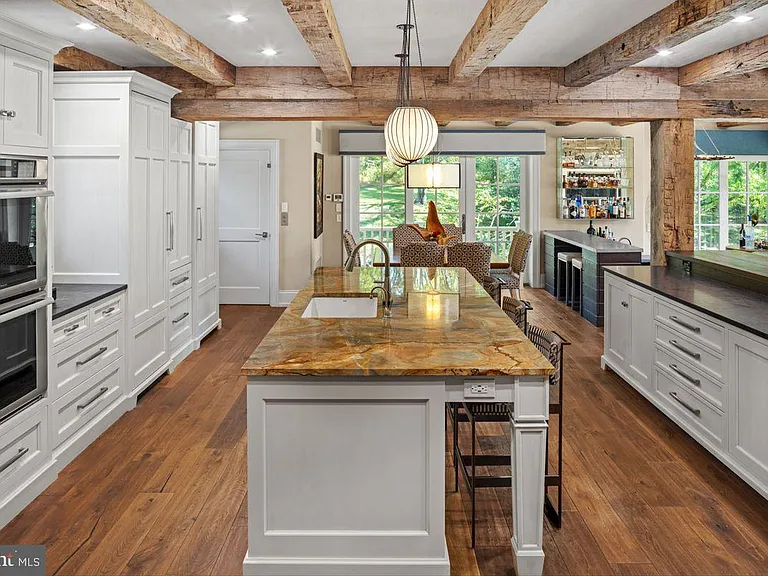 1700s equestrian estate in Lower Gwynedd Pennsylvania, colonial era kitchen with exposed wood beams and new miele appliances