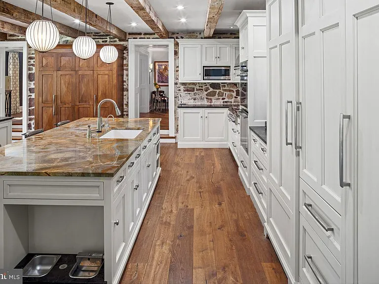 1700s equestrian estate in Lower Gwynedd Pennsylvania, colonial era kitchen with exposed wood beams and new miele appliances