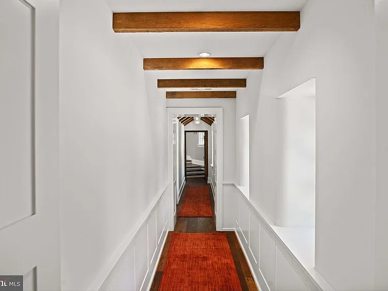 1700s equestrian estate in Lower Gwynedd Pennsylvania, colonial era       hallway with wood flooring and red carpet