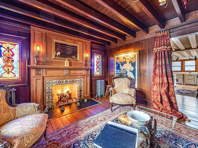 Timeless NJ bayfront beach house, rustic interior living room of 612 S Bayview Drive in Strathmere, New Jersey with exposed wood beams and mahogony