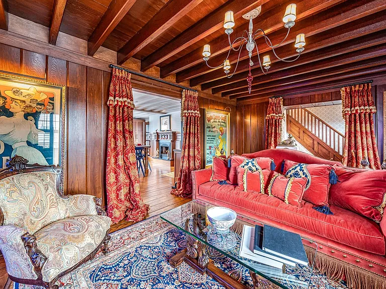 Timeless NJ bayfront beach house, rustic interior living room of 612 S Bayview Drive in Strathmere, New Jersey with exposed wood beams and mahogony