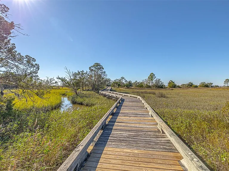 Most beautiful mansion on Saint Simons Island, Georgia, exterior and wood boarkwalk through nature