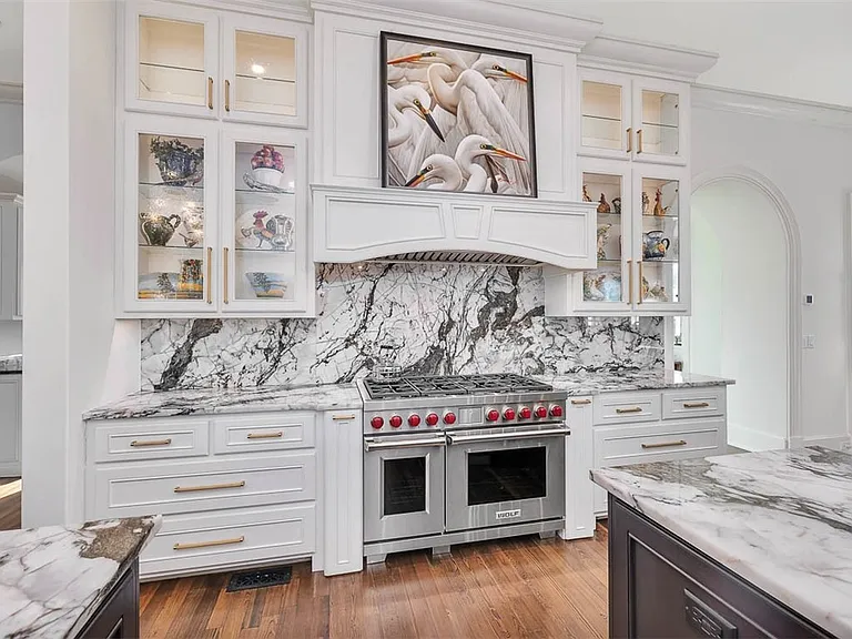 Most beautiful mansion on Saint Simons Island, Georgia, black white and gold quartzite kitchen with double Wolf range