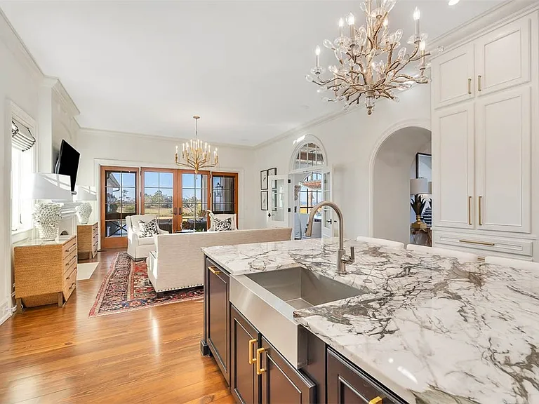 Most beautiful mansion on Saint Simons Island, Georgia, black white and gold quartzite kitchen with eat-in breakfast nook