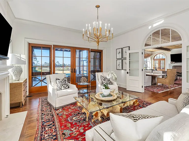 Most beautiful mansion on Saint Simons Island, Georgia, white red and gold living room with natural wood finishes