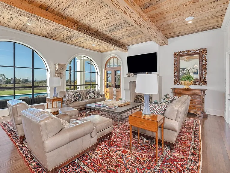 Most beautiful mansion on Saint Simons Island, Georgia, interior living room with high wood beamed ceilings overlooking the jekyll bridge