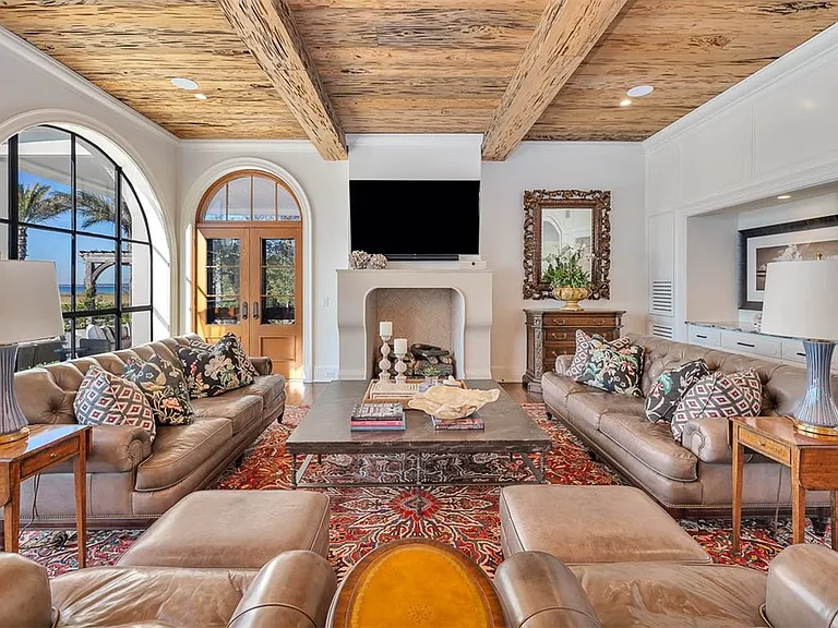 Most beautiful mansion on Saint Simons Island, Georgia, interior living room with high wood beamed ceilings overlooking the jekyll bridge