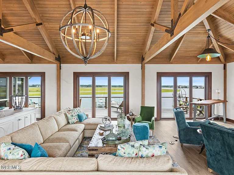 Wilmington Beach Mansion with Panoramic Views, renovated turquoise and natural wood living room with vaulted ceilings and exposed wood